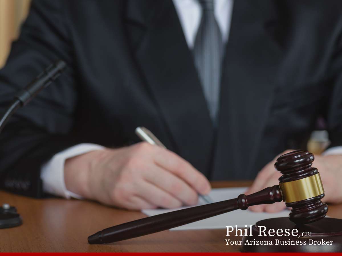 Business broker reviewing documents with a gavel on the table, keyword: Business’s Financials